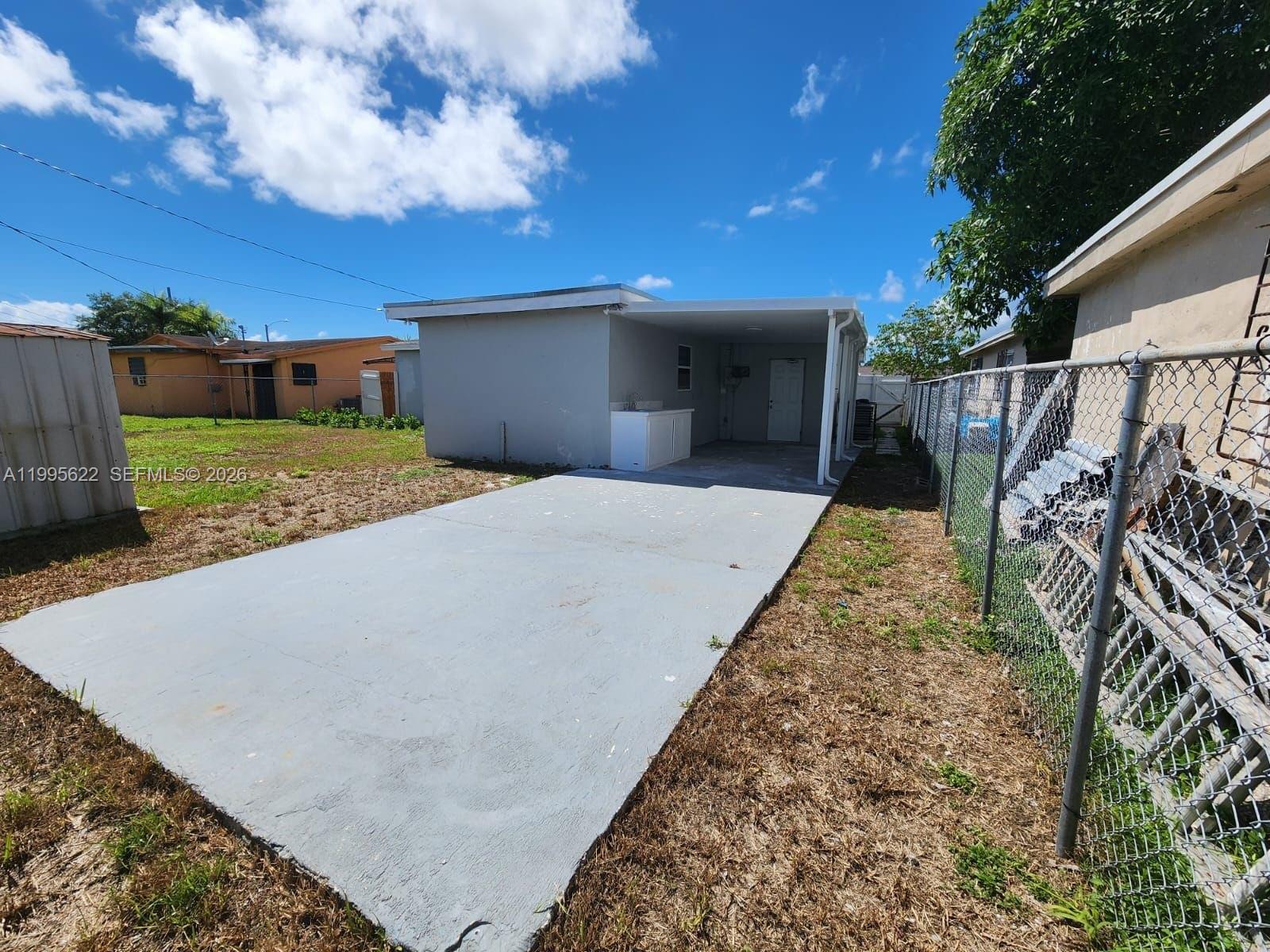 10745 Southwest 222nd Street, Unit 10745 Miami, FL 33170 - Photo 25 of 26 a view of a backyard with a garden and tree