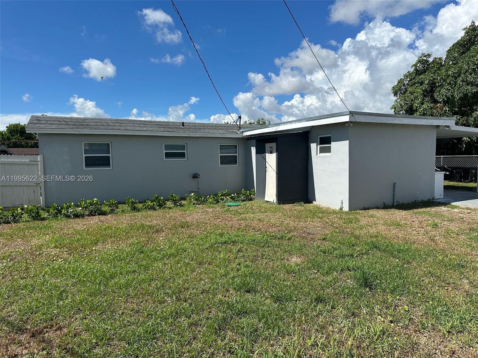 10745 Southwest 222nd Street, Unit 10745 Miami, FL 33170 - Photo 26 of 26 a view of a house with a backyard