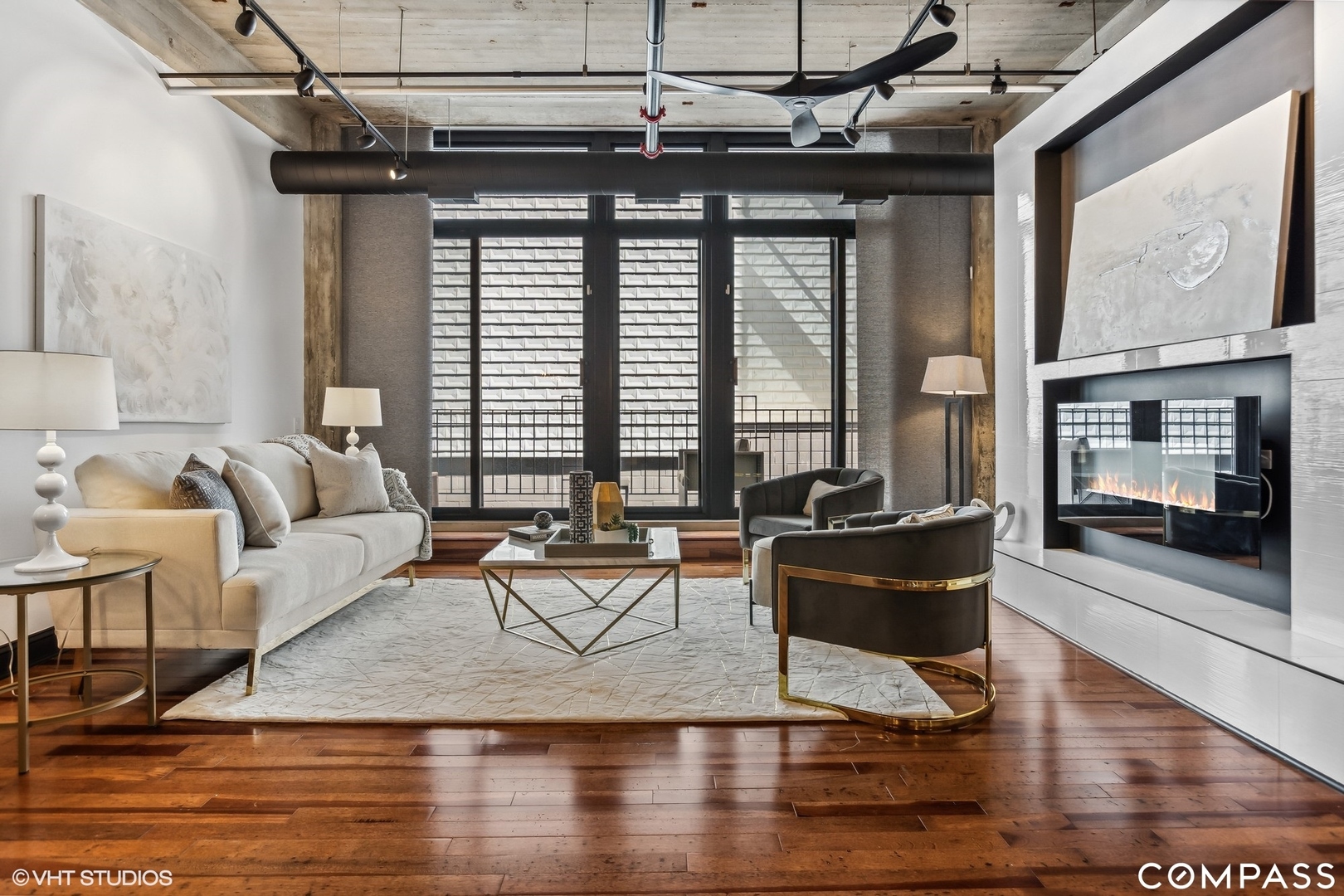 850 West Adams Street, Unit 2E Chicago, IL 60607 - Photo 12 of 36 a living room with couches and a dining table with wooden floor