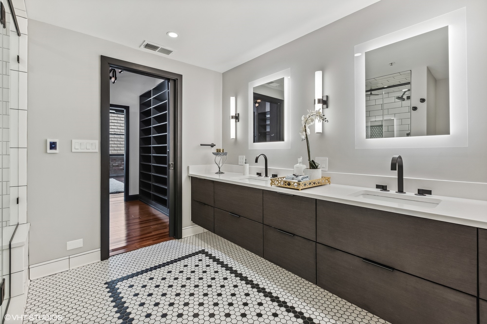 850 West Adams Street, Unit 2E Chicago, IL 60607 - Photo 23 of 36 a en suite bathroom with a double vanity sink and a mirror