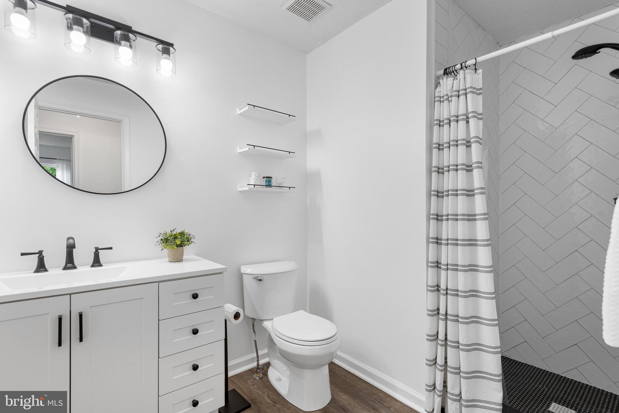 12004 Taliesin Place, Unit 32 Reston, VA 20190 - Photo 16 of 26 a bathroom with a toilet a sink and mirror