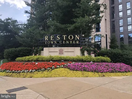 a street sign in front of flowers