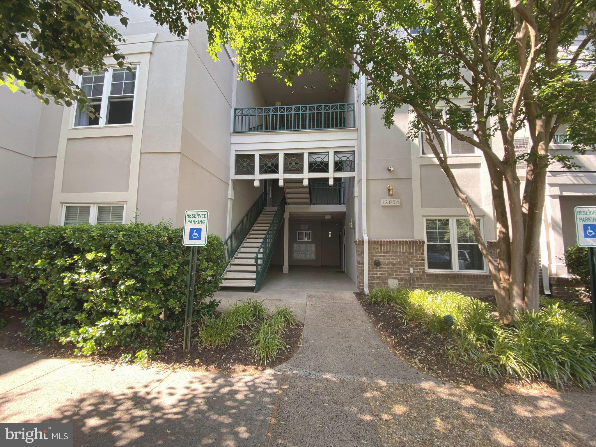 12004 Taliesin Place, Unit 32 Reston, VA 20190 - Photo 4 of 26 a front view of a house with a yard