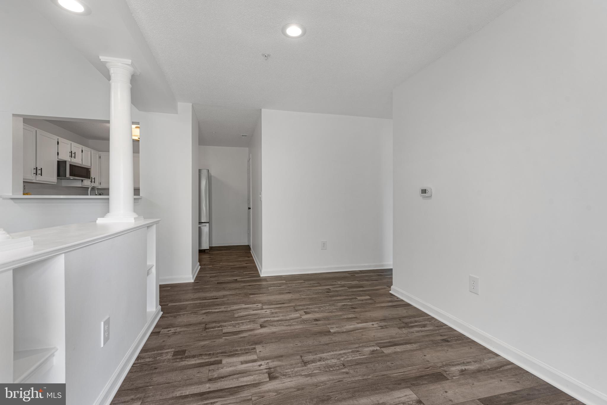12004 Taliesin Place, Unit 32 Reston, VA 20190 - Photo 8 of 26 a view of a hallway with wooden floor and a bathroom