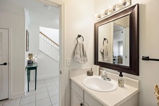 a bathroom with a sink vanity and mirror