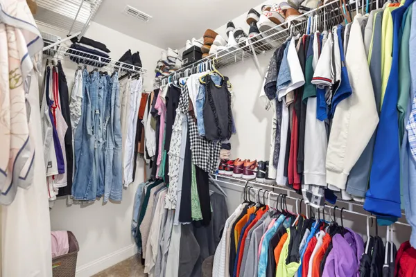 a view of walk in closet with clothes