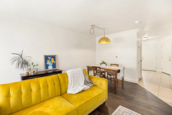 a living room with a couch and piano table