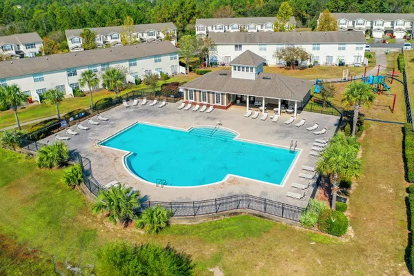an aerial view of a house with outdoor space pool seating area and yard