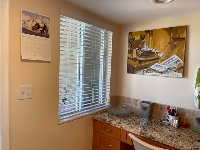 a kitchen with granite countertop a sink a stove and a microwave