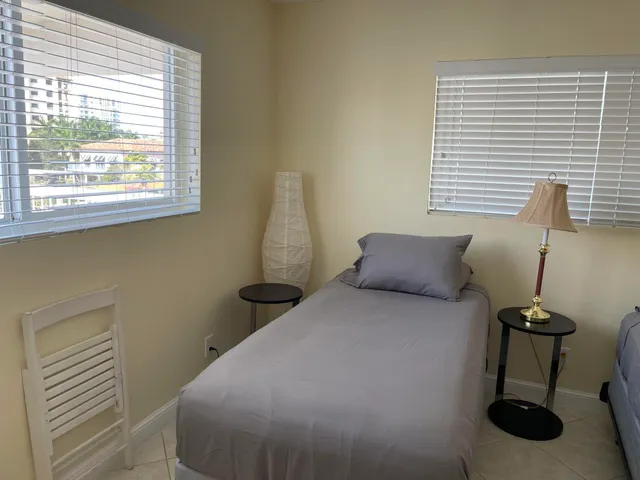 a bedroom with two beds and a window