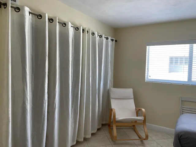 a bathroom with a glass door shower a sink and a toilet