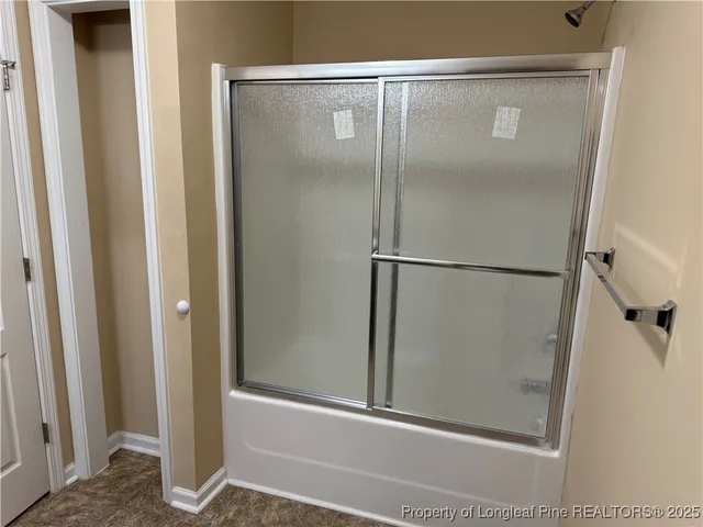 a bathroom with a glass shower door