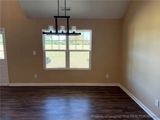 a view of wooden floor and windows in a room