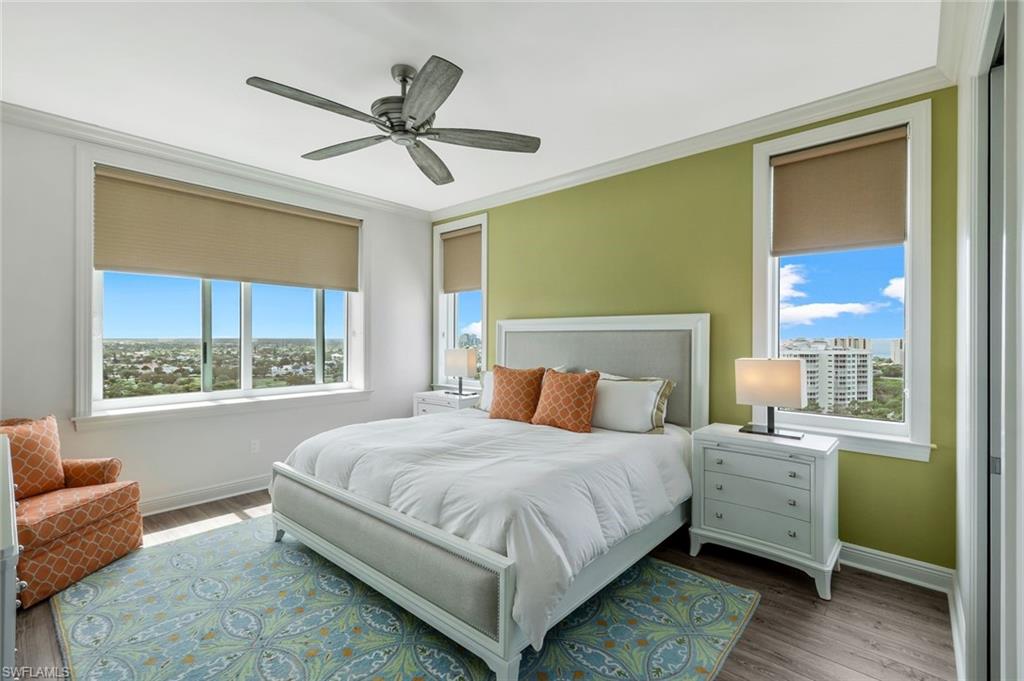 275 Indies Way, Unit 1701 Naples, FL 34110 - Photo 24 of 32 a bedroom with a bed couch and window