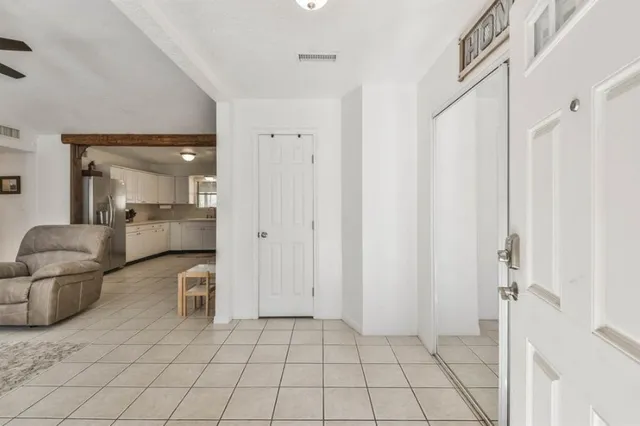 a spacious bathroom with a mirror and a shower