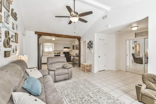 a living room with furniture and a large window