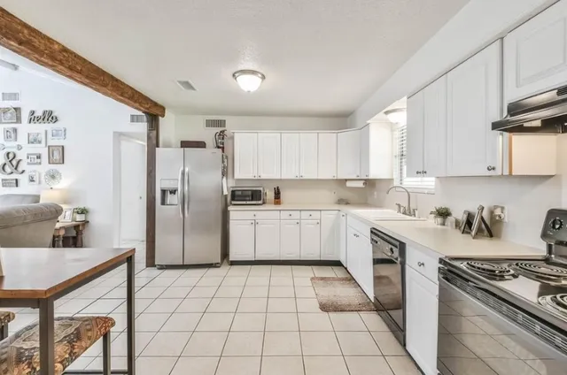 a kitchen with a stove a sink and a refrigerator