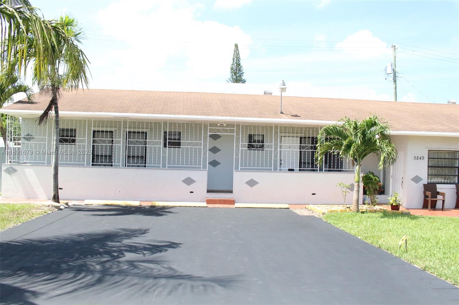 a front view of a house with a garden and plants