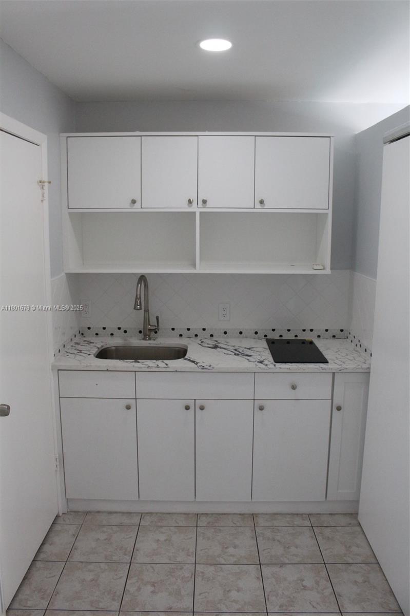 5849 Wiley Street, Unit 2 Hollywood, FL 33023 - Photo 4 of 10 a kitchen with a sink and cabinets