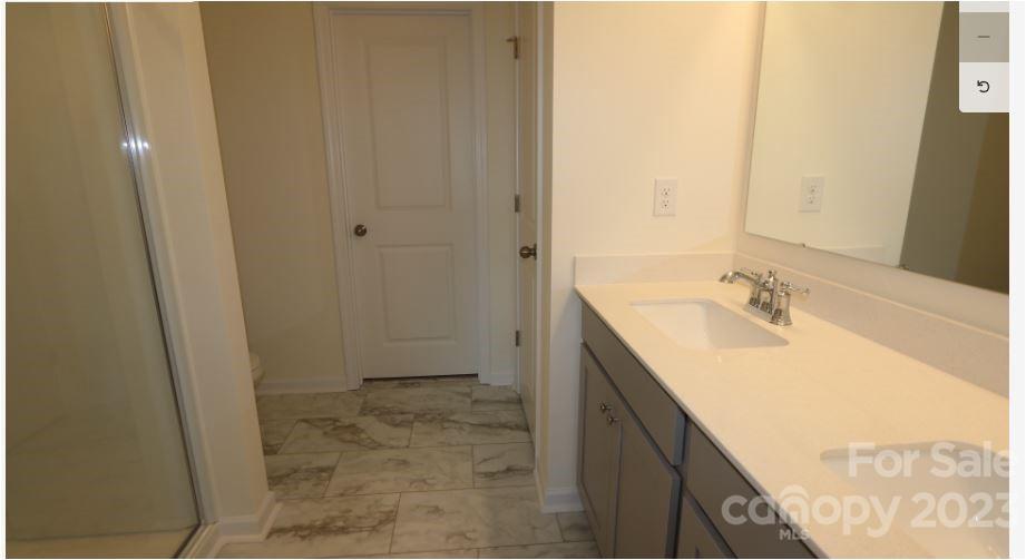 2804 Trinity Street Monroe, NC 28110 - Photo 15 of 17 a bathroom with a granite countertop sink and a mirror