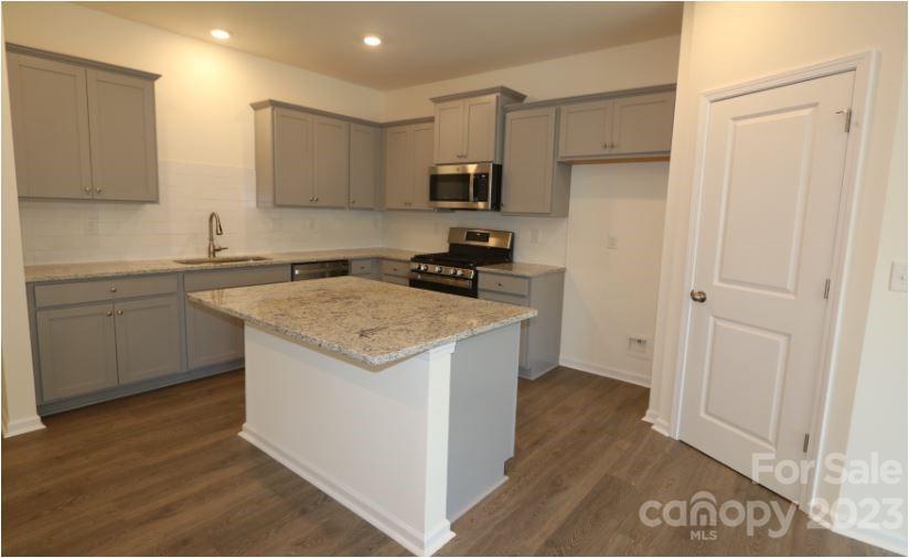 2804 Trinity Street Monroe, NC 28110 - Photo 5 of 17 a kitchen with stainless steel appliances granite countertop a stove a sink and a refrigerator