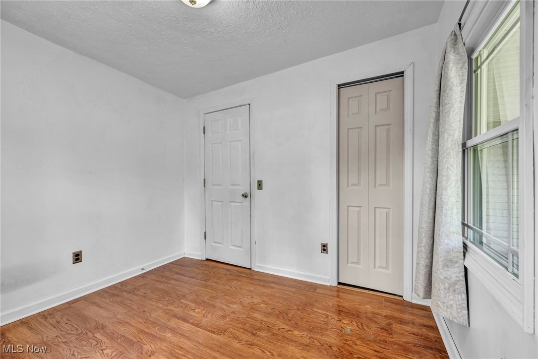 39020 Center Ridge Road North Ridgeville, OH 44039 - Photo 21 of 30 Unfurnished bedroom with a textured ceiling and hardwood / wood-style flooring