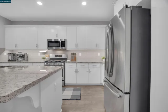 a kitchen with a refrigerator stove and sink