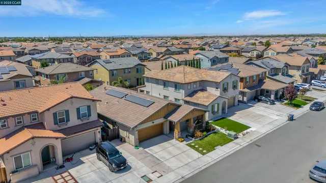 an aerial view of a houses with a city view