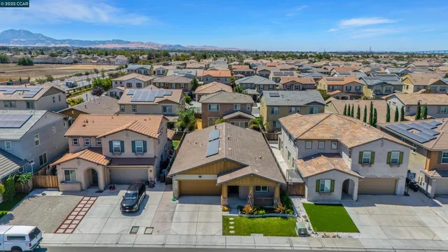 an aerial view of multiple houses with a yard