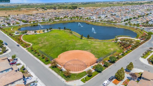 an aerial view of a residential building with swimming pool and ocean view
