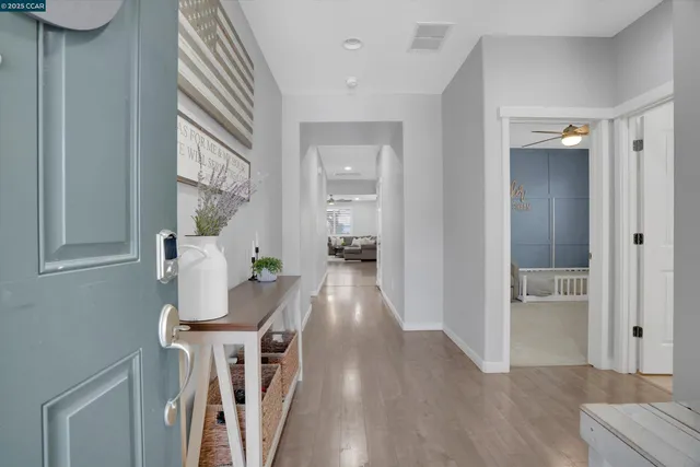 a view of a hallway view with wooden floor and staircase