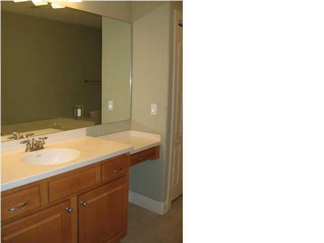 263 Diamond Cove, Unit 263 Destin, FL 32541 - Photo 16 of 24 a bathroom with a sink and a mirror