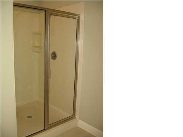 263 Diamond Cove, Unit 263 Destin, FL 32541 - Photo 17 of 24 a bathroom with a shower and a glass door