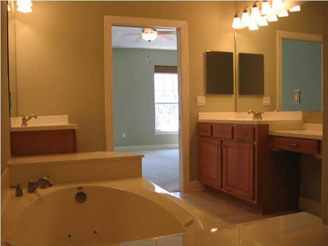 263 Diamond Cove, Unit 263 Destin, FL 32541 - Photo 18 of 24 a bathroom with a tub sink and mirror