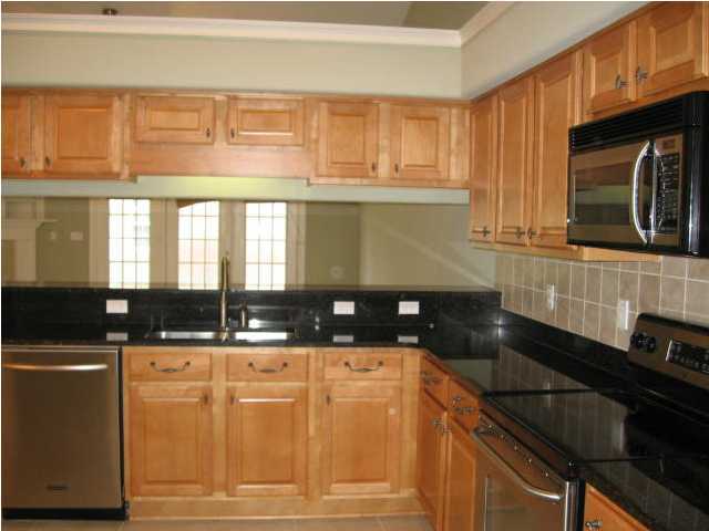 263 Diamond Cove, Unit 263 Destin, FL 32541 - Photo 3 of 24 a kitchen with granite countertop a sink and a stove