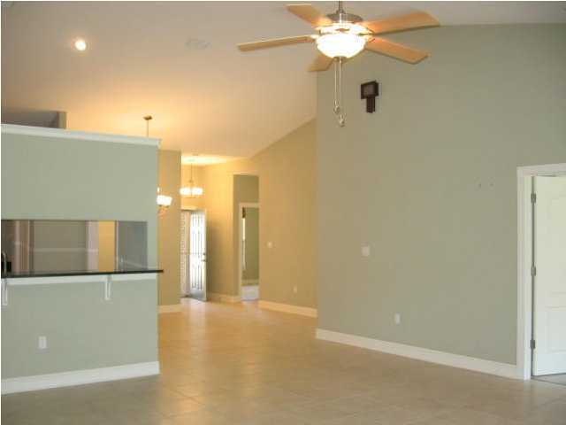 263 Diamond Cove, Unit 263 Destin, FL 32541 - Photo 7 of 24 a view of a kitchen with a sink a refrigerator a kitchen and a chandelier