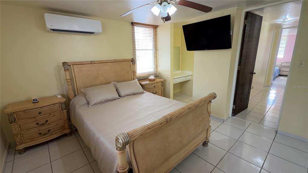 1 St Rio Grande, Unit B6 Rio Grande, PR 00745 - Photo 46 of 47 a bed room with a bed and a television