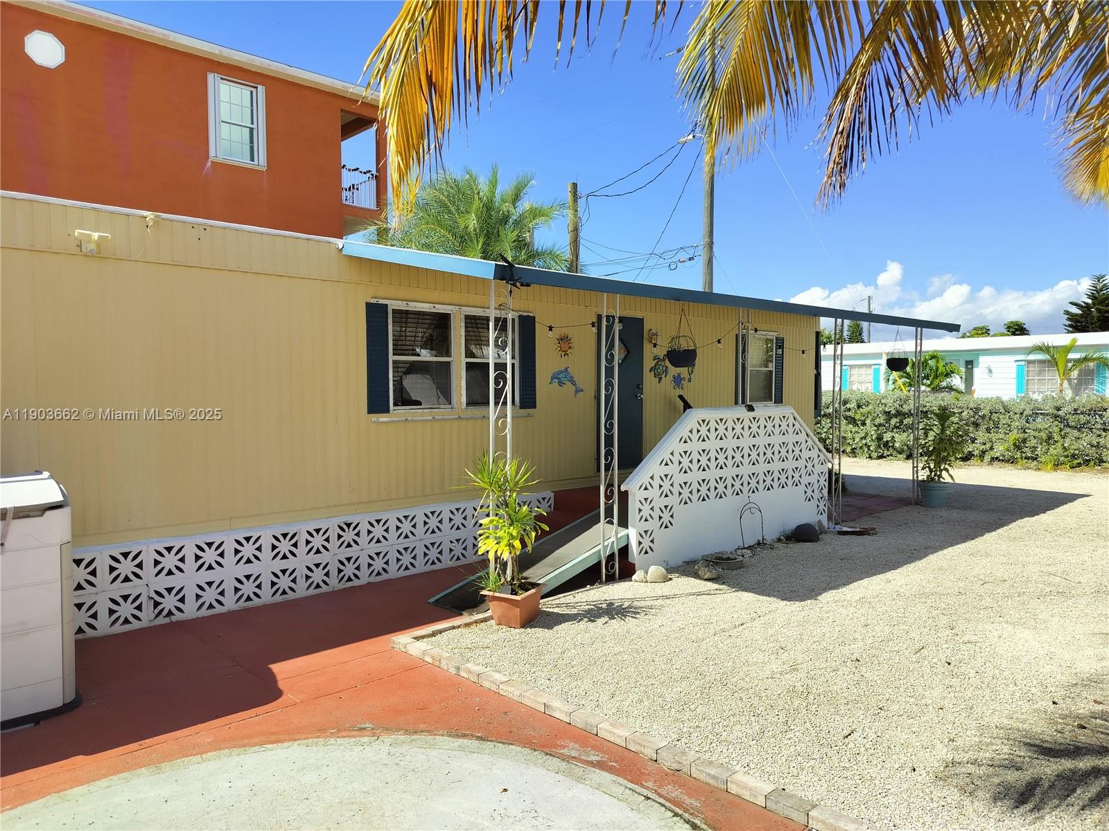 206 West 2nd Court Key Largo, FL 33037 - Photo 3 of 53 a front view of a house with a garage