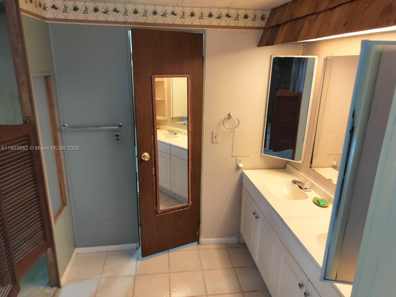 206 West 2nd Court Key Largo, FL 33037 - Photo 32 of 53 a bathroom with a granite countertop sink and a mirror