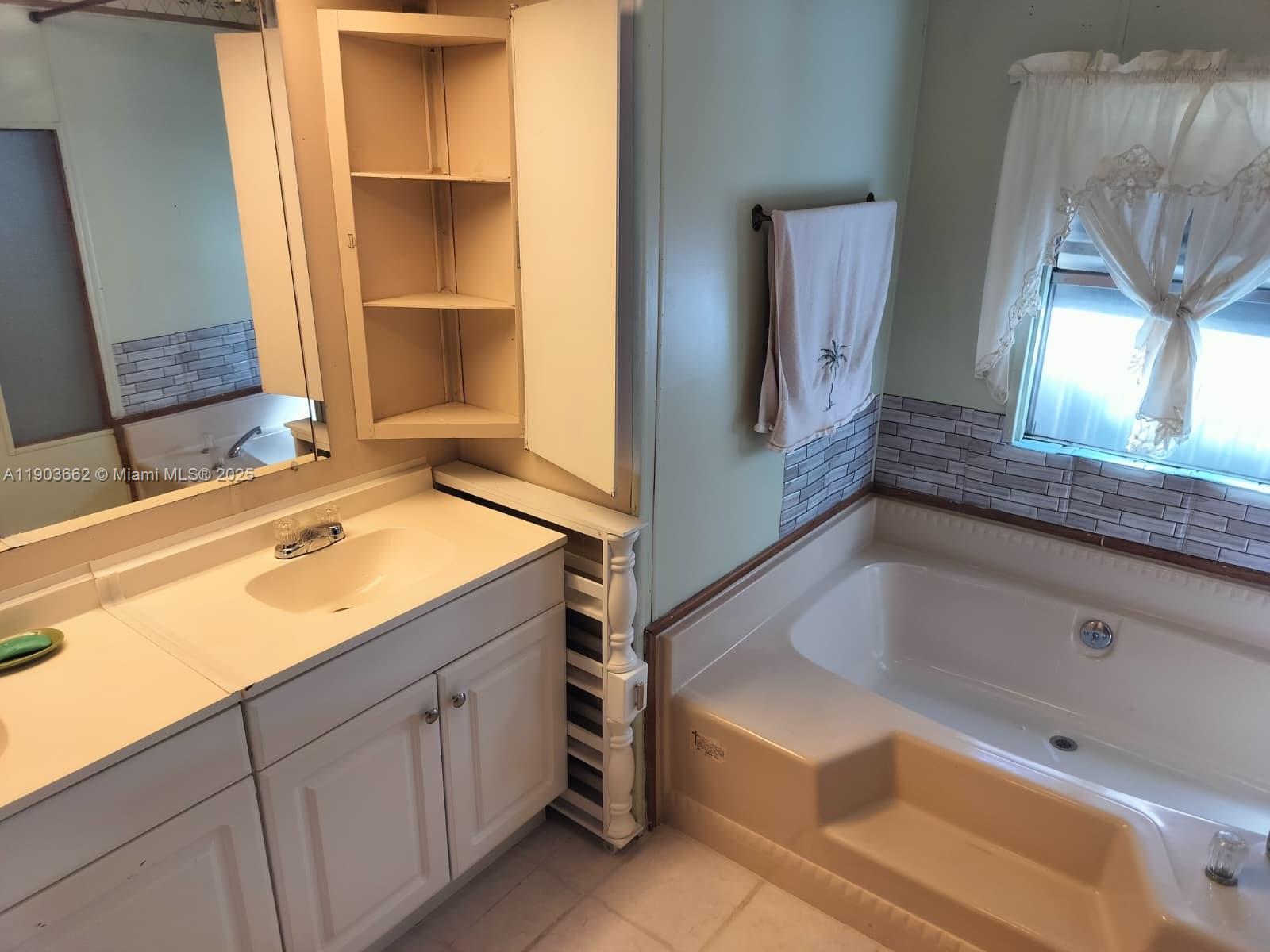 206 West 2nd Court Key Largo, FL 33037 - Photo 33 of 53 a bathroom with a tub sink and mirror
