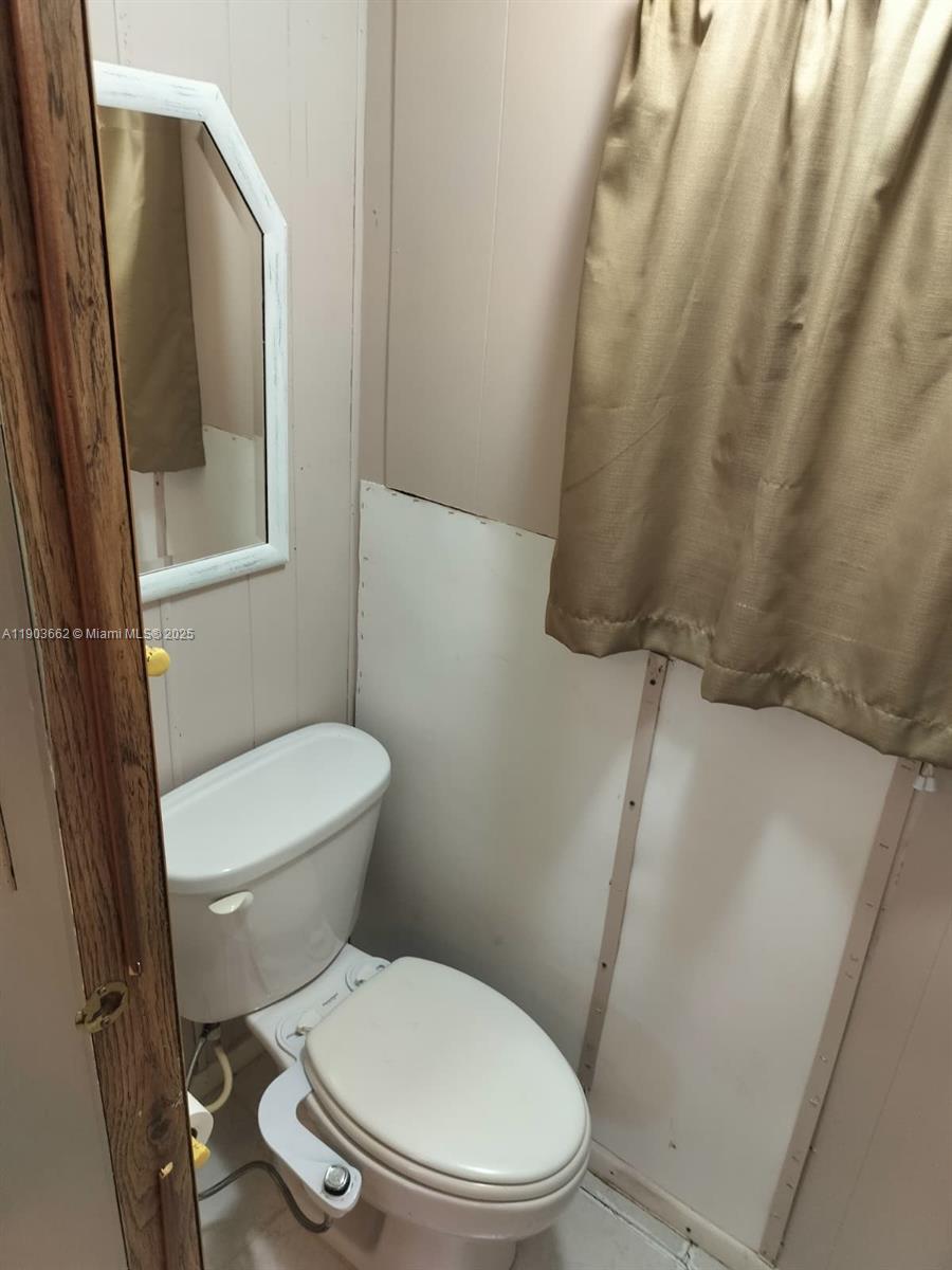 206 West 2nd Court Key Largo, FL 33037 - Photo 34 of 53 a white toilet sitting next to a small sink