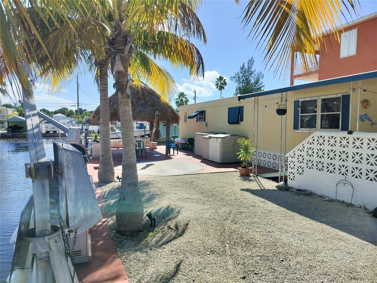 206 West 2nd Court Key Largo, FL 33037 - Photo 4 of 53 a row of palm trees in front of a house