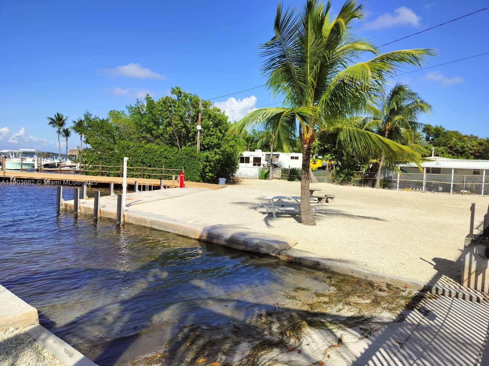 206 West 2nd Court Key Largo, FL 33037 - Photo 49 of 53 a view of a swimming pool with a lounge chairs