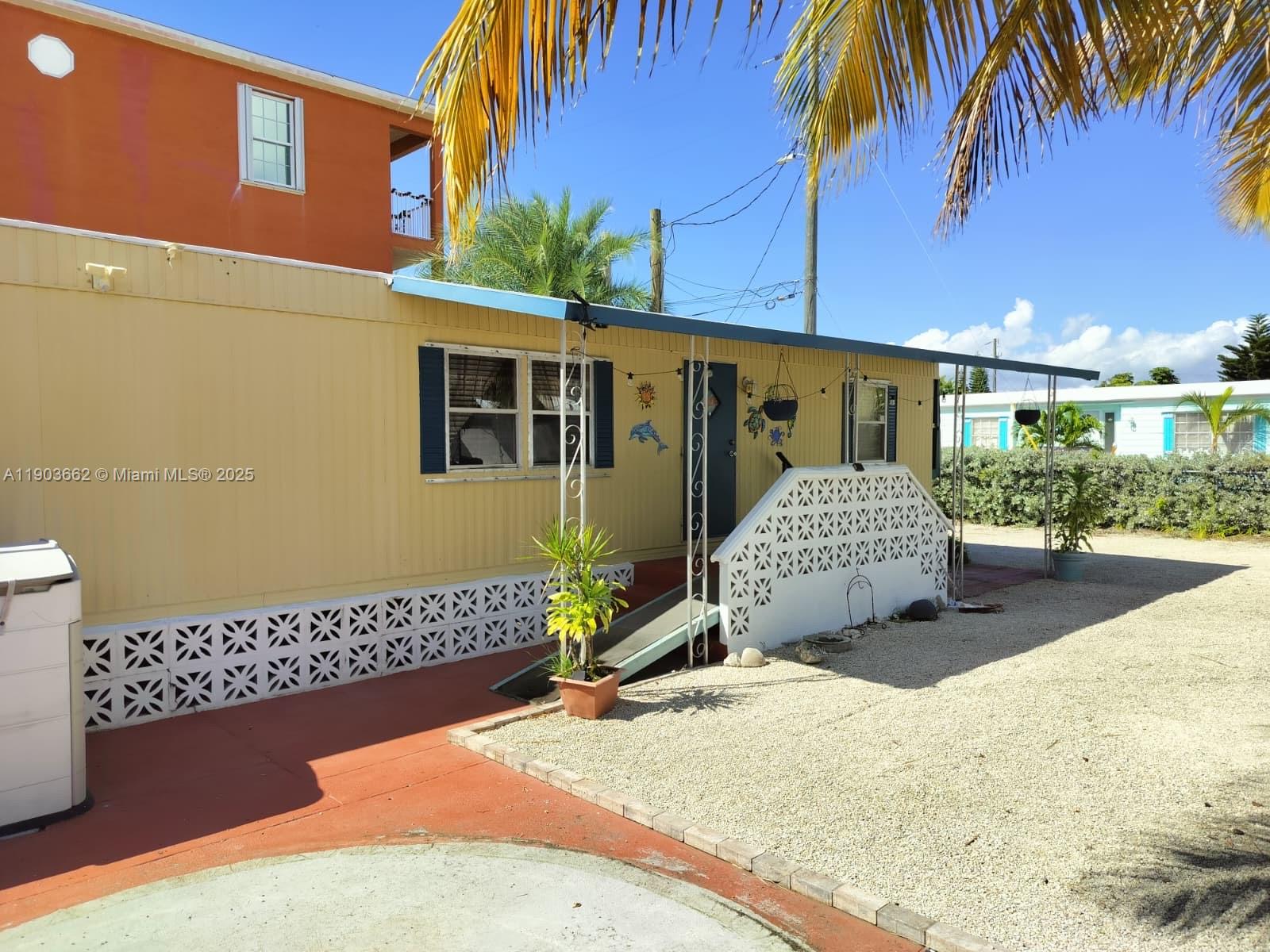 206 West 2nd Court Key Largo, FL 33037 - Photo 5 of 53 a front view of a house with a garage