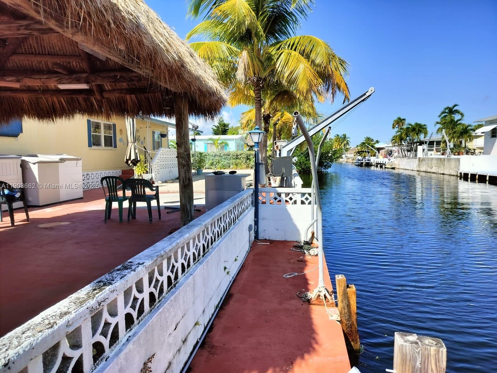 206 West 2nd Court Key Largo, FL 33037 - Photo 8 of 53 a balcony with wooden floor table and chairs