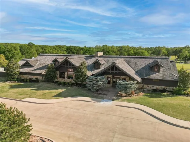 an aerial view of a house with a yard
