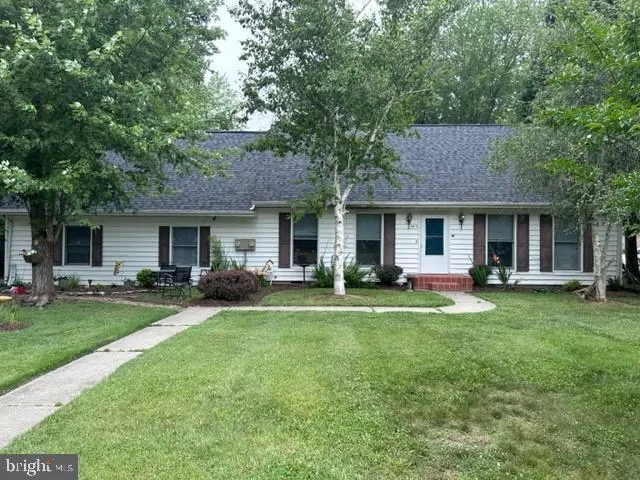 a front view of a house with a garden and porch
