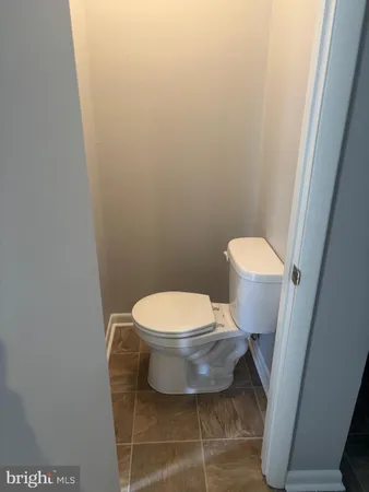 a white toilet sitting next to a white sink