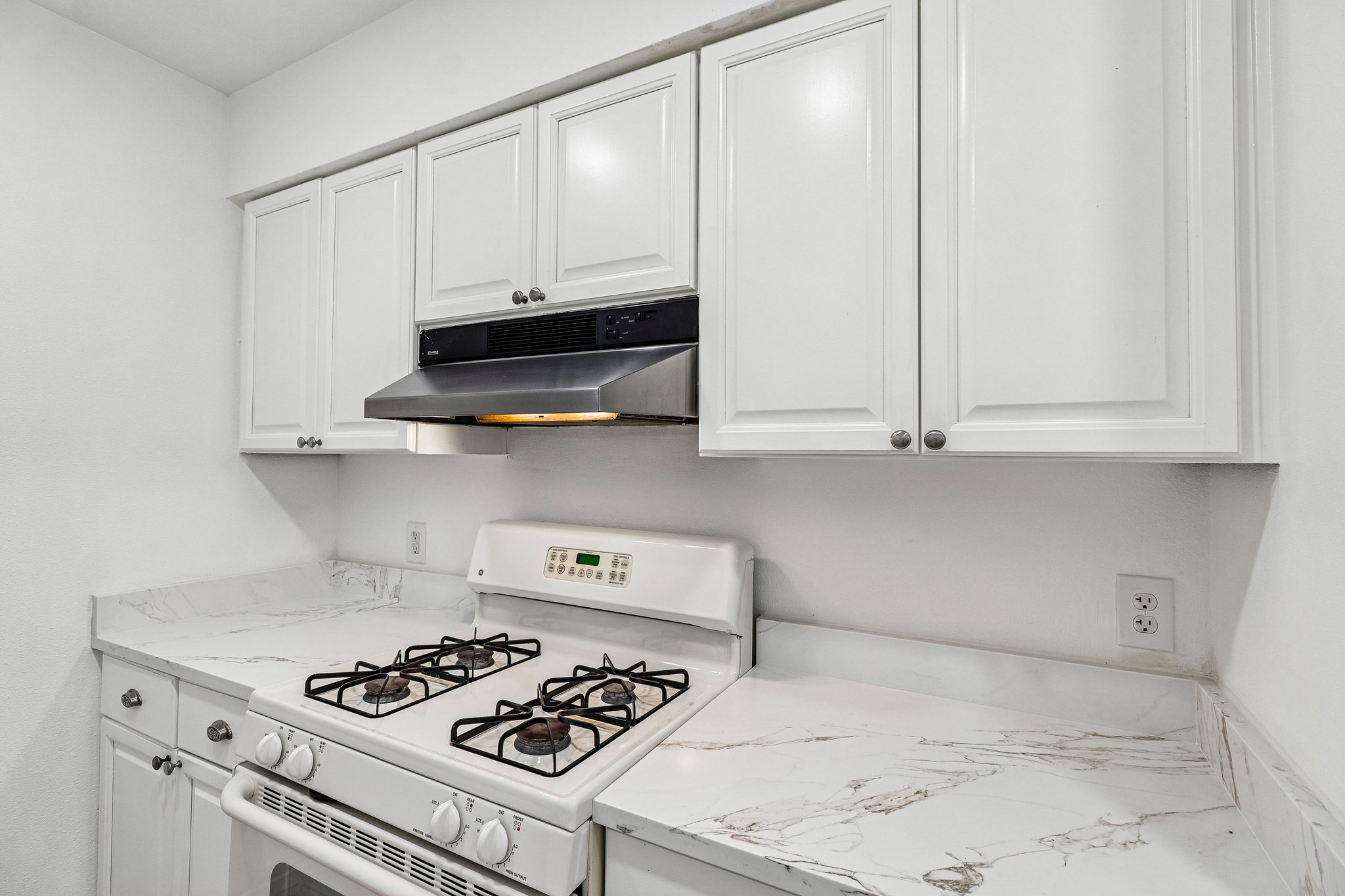 5809 Coventry Lane Austin, TX 78723 - Photo 5 of 35 White cabinetry with sleek countertops and a gas stove.