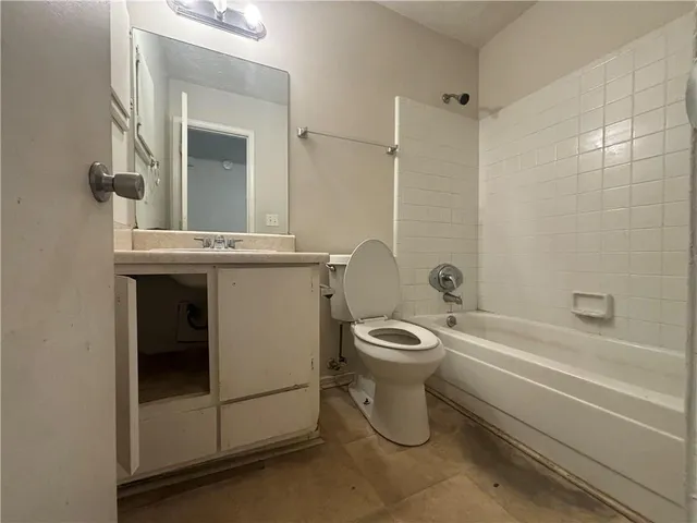 a bathroom with a toilet a sink and bathtub